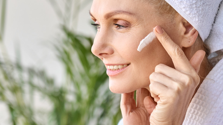 female applying sunscreen