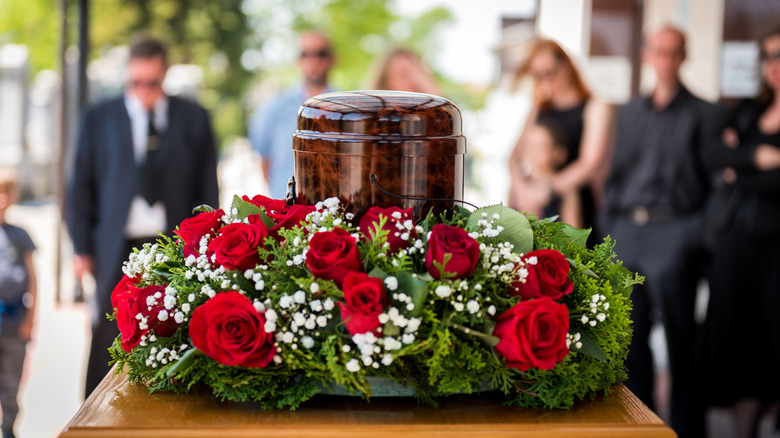 Urn with roses and mourners 