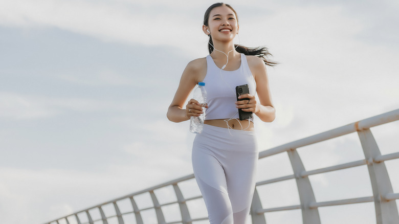 Smiling woman jogs