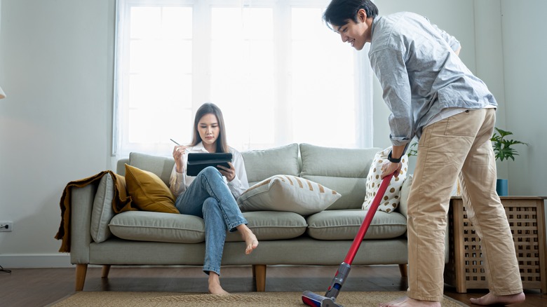 man vacuuming the house