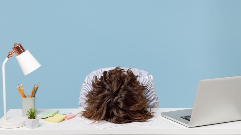 person sleeping at desk