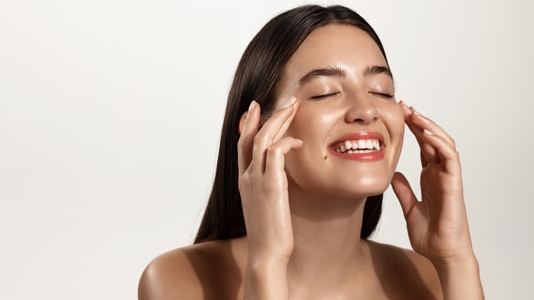 Smiling woman showing off hydrated complexion