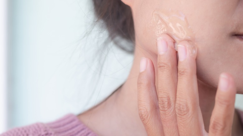 Person applying a peeling gel or face gel