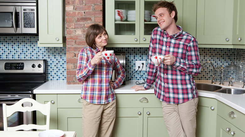 couple in kitchen wearing matching outfits