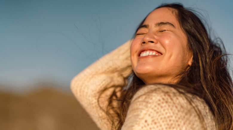 smiling woman enjoying sun