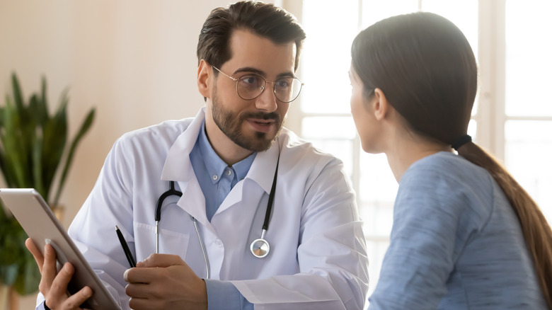 woman speaking to doctor about risks