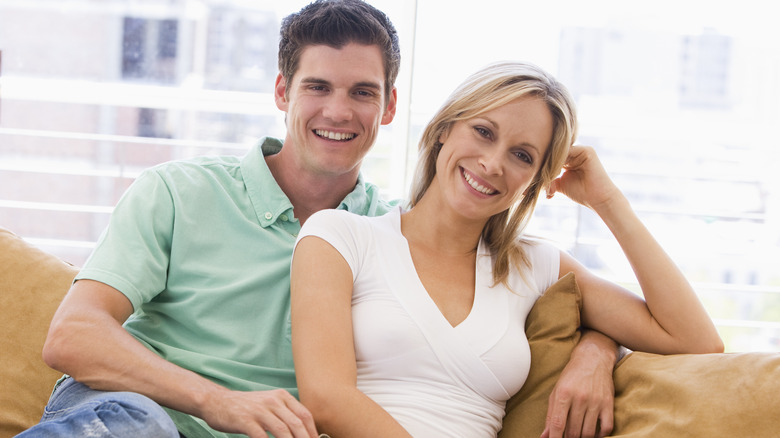 smiling couple on sofa