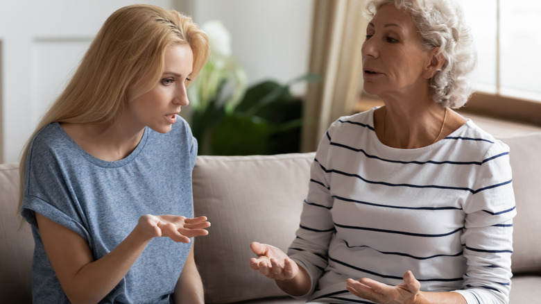 two women arguing on sofa