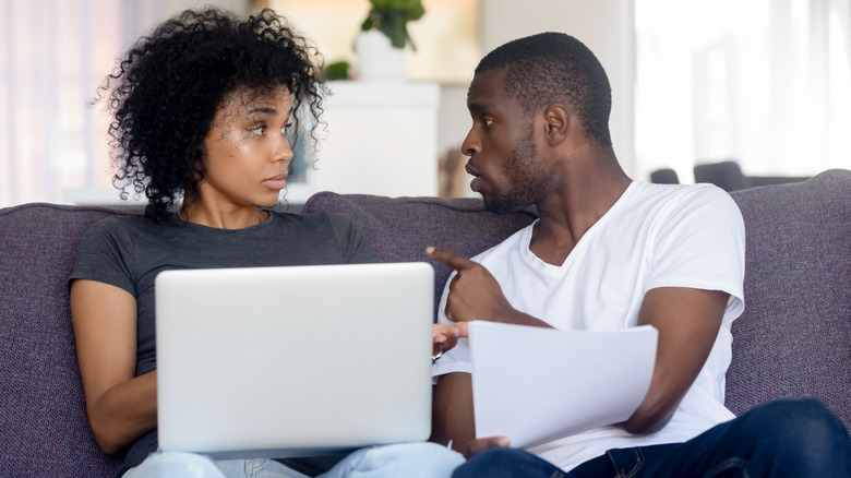 couple with laptop arguing