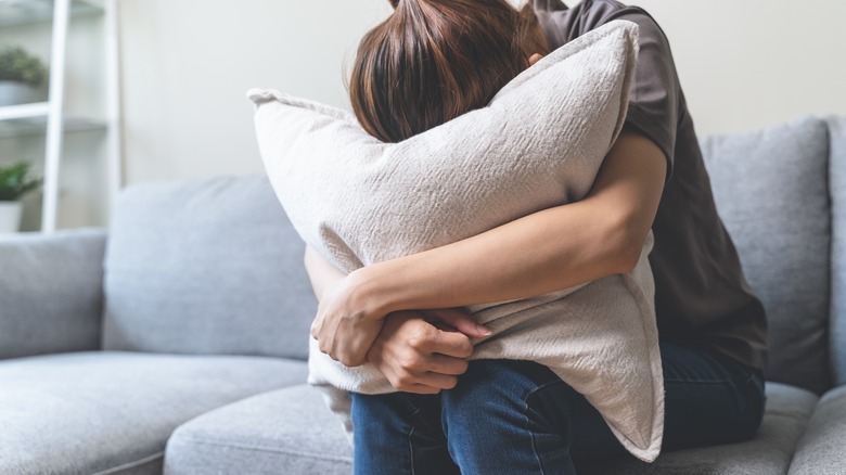 Woman hugging pillow