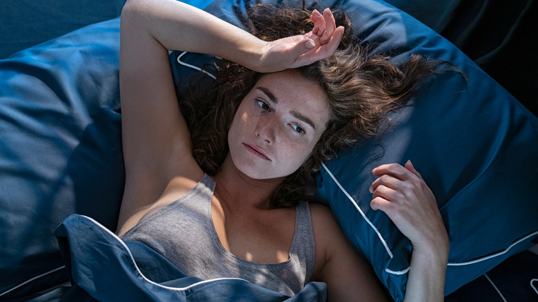 Woman contemplating in bed