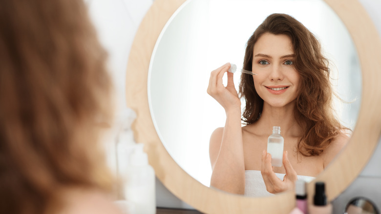 woman applying serum 