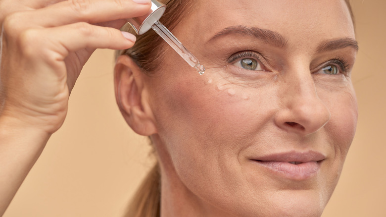 woman applying serum 