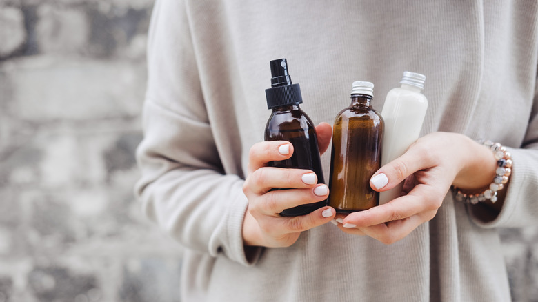 woman holding skincare products