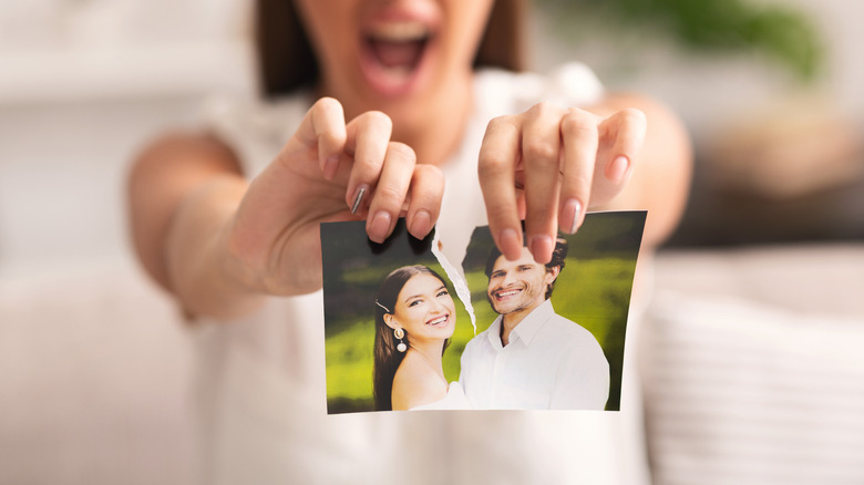 woman ripping couple's photo