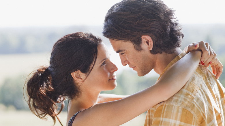 Young couple hugging outside