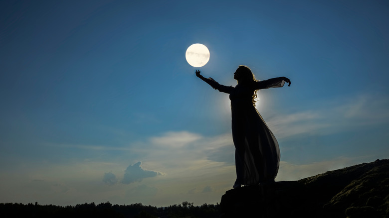 woman dancing under moon