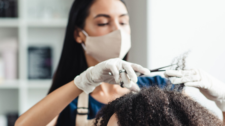 hairdresser wearing gloves and masks