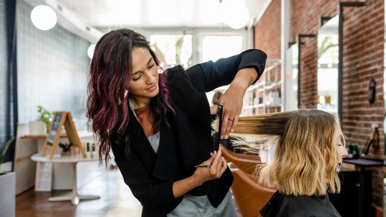 Woman cutting woman's hair