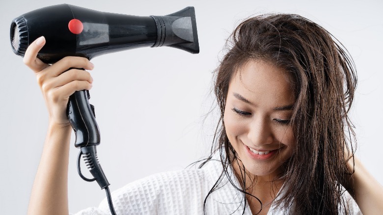 Woman blow drying hair