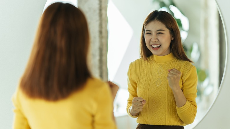 Woman smiling in mirror