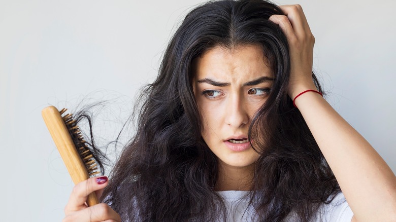 woman experiencing hair loss