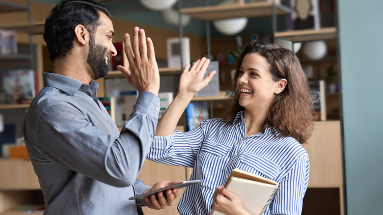 people high-five at work