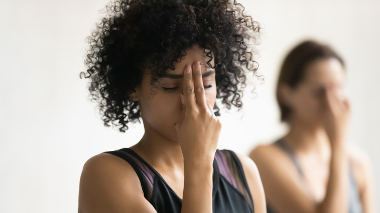 two women practicing breathing exercises