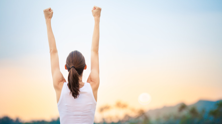 woman celebrating with fists in the air