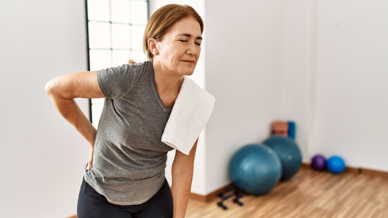 Woman in pain at gym