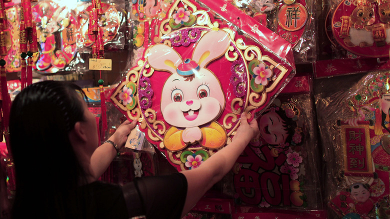 woman buying rabbit decoration