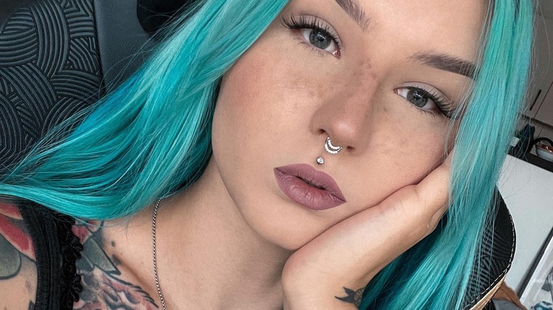 woman with blue hair and medusa piercing
