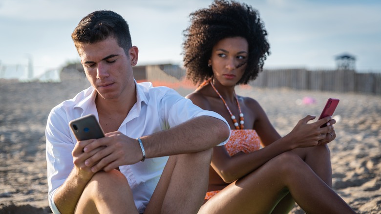 Jealous partner staring at man