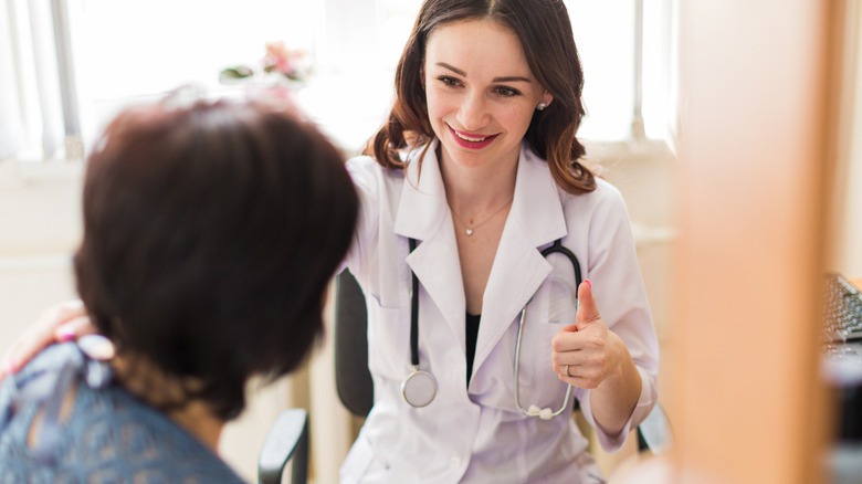 Female doctor giving thumbs up