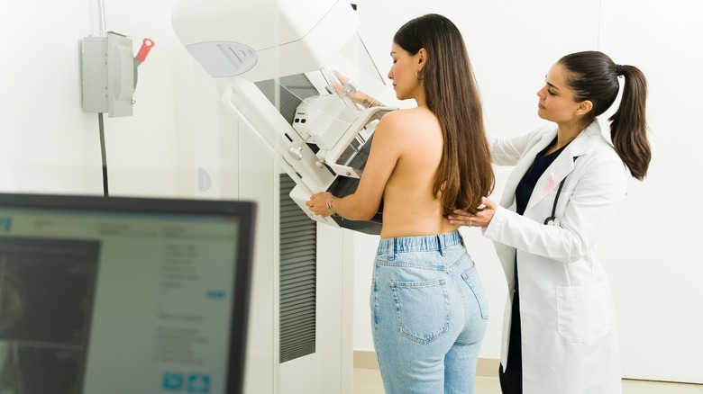 Topless woman getting mammogram