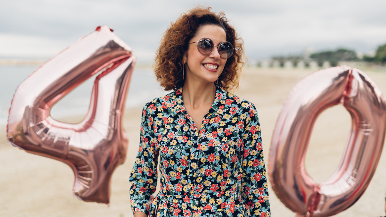 Woman with '40' birthday balloons