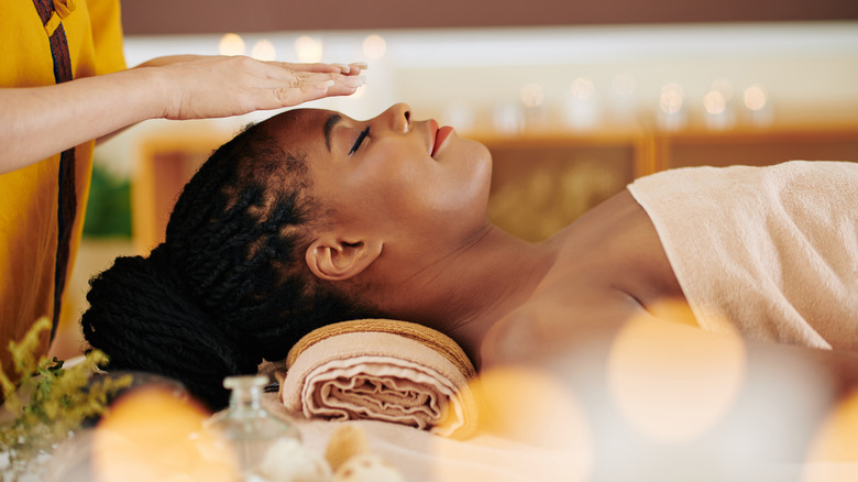 Black woman receiving reiki