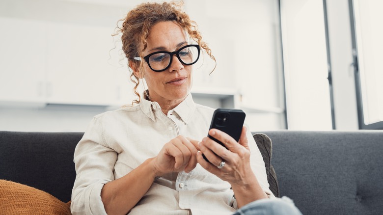 Woman scrolls on phone