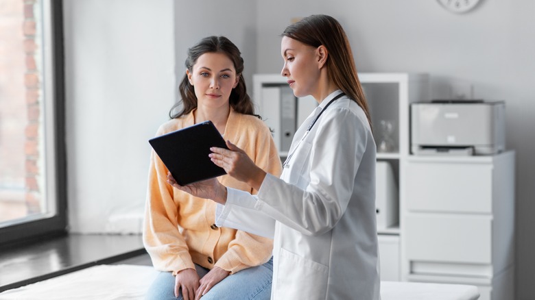 Woman talking to female doctor