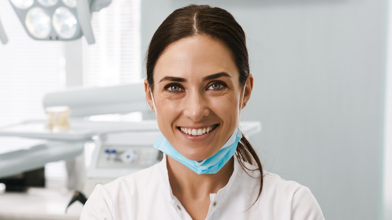 Dentist smiling in clinical setting