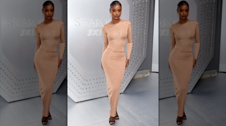 Justine Skye wearing beige sheath dress