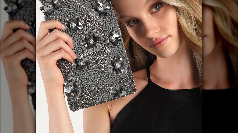 Lulus model holds sequined clutch