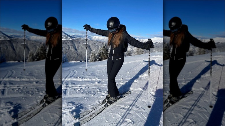 Skiier in all-black ensemble