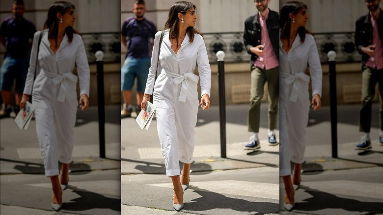 Woman in white jumpsuit and heels