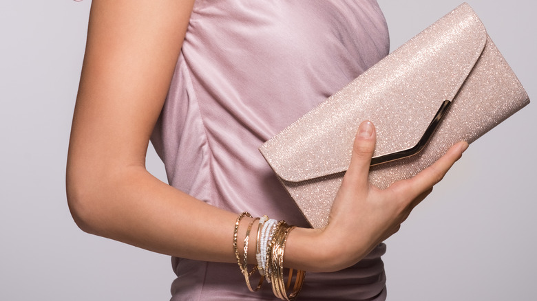 Woman holding small clutch