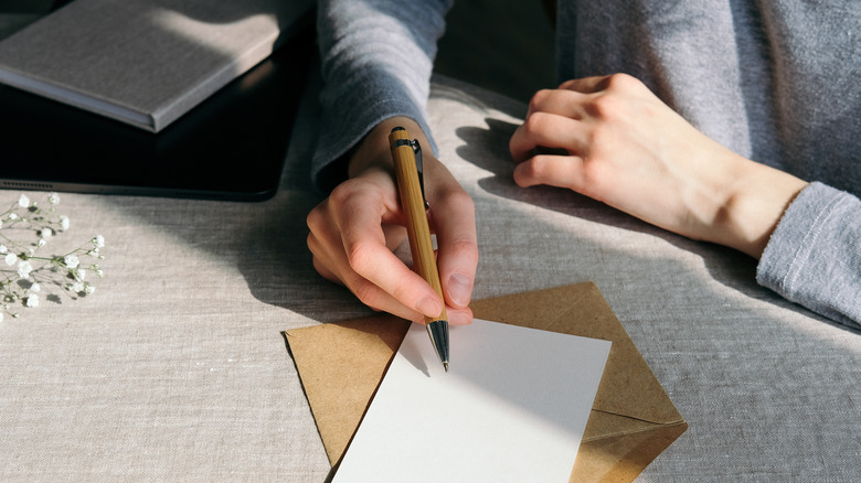 Woman writing note in card