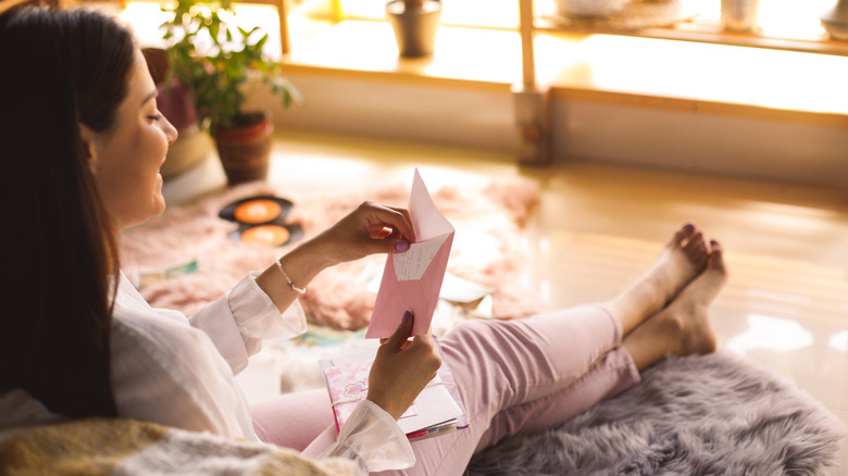 Woman opening envelope