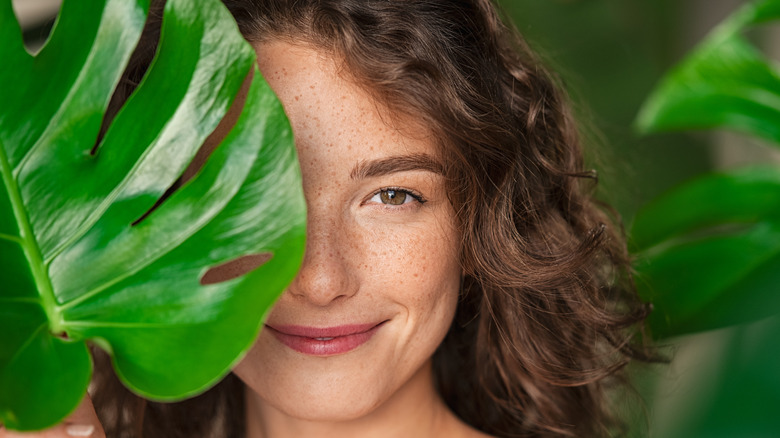 A woman holding a leaf