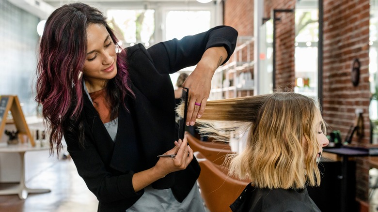 hairdresser cutting short dry hair