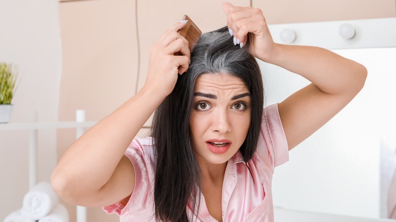 Woman looking at gray roots